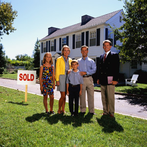 Family Posing Outside their New House